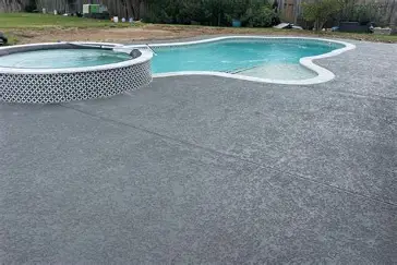 Resurfaced grey pool deck and patio by R&L Spray Deck in Houston